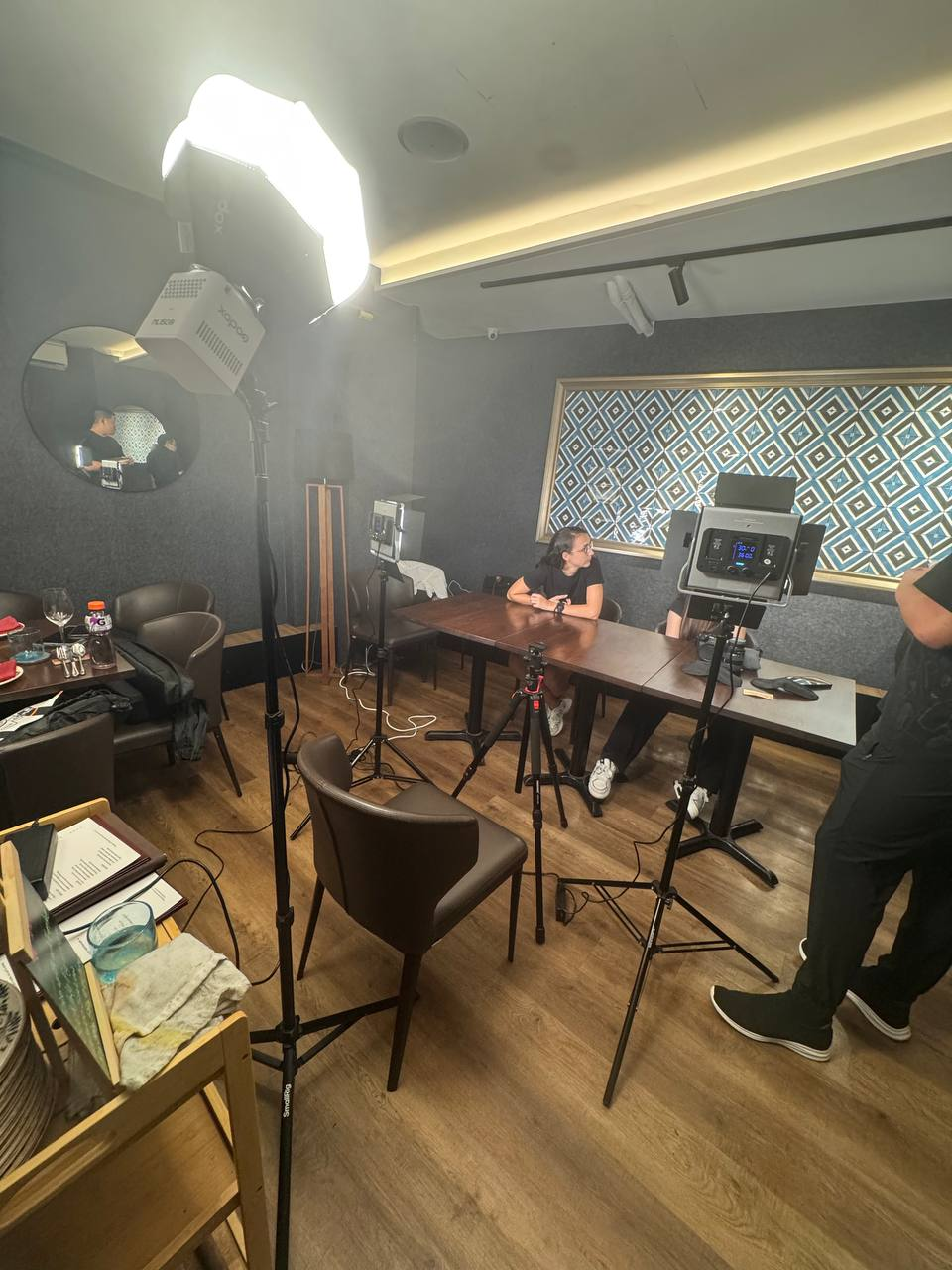 Wide view of a content shoot in progress: tripods, lighting and a dressed table